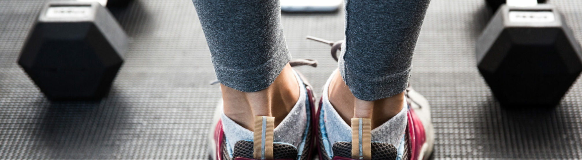 Closeup image of a female legs at gym